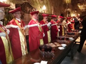 Red robes and Chinon wine, in a cave